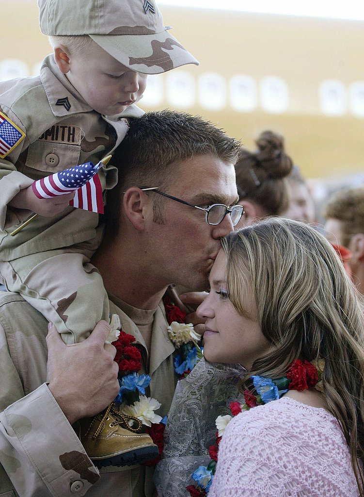 In 2004, Army Sgt. Cody Smith kisses his wife, Kelsie, while his nephew Brandon looks on in Salt Lake City, UT.
In 2004, Army Sgt. Cody Smith kisses his wife, Kelsie, while his nephew Brandon looks on in Salt Lake City, UT.