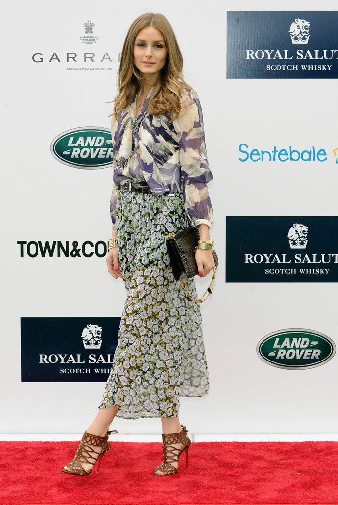 Olivia played with prints at the Sentebale Royal Salute Polo Cup in a sheer top and maxi, both adorned with watercolor floral prints. She added structure with a black belt and decadent croc bag, and finished everything off with a pair of on-trend sandal booties from Christian Louboutin.
Olivia played with prints at the Sentebale Royal Salute Polo Cup in a sheer top and maxi, both adorned with watercolor floral prints. She added structure with a black belt and decadent croc bag, and finished everything off with a pair of on-trend sandal booties from Christian Louboutin.