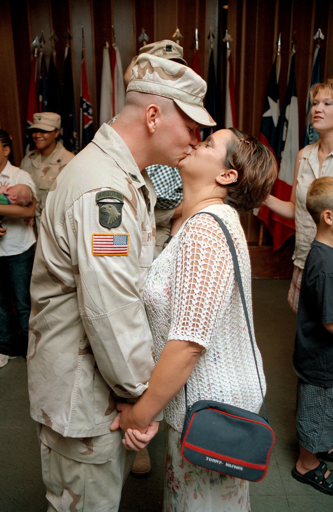 US Army Military Policeman Marc Runge and his wife, Valerie, shared a sweet kiss after a welcome home and award ceremony on July 26, 2002, at Fort Polk, LA, following seven months of deployment.
US Army Military Policeman Marc Runge and his wife, Valerie, shared a sweet kiss after a welcome home and award ceremony on July 26, 2002, at Fort Polk, LA, following seven months of deployment.