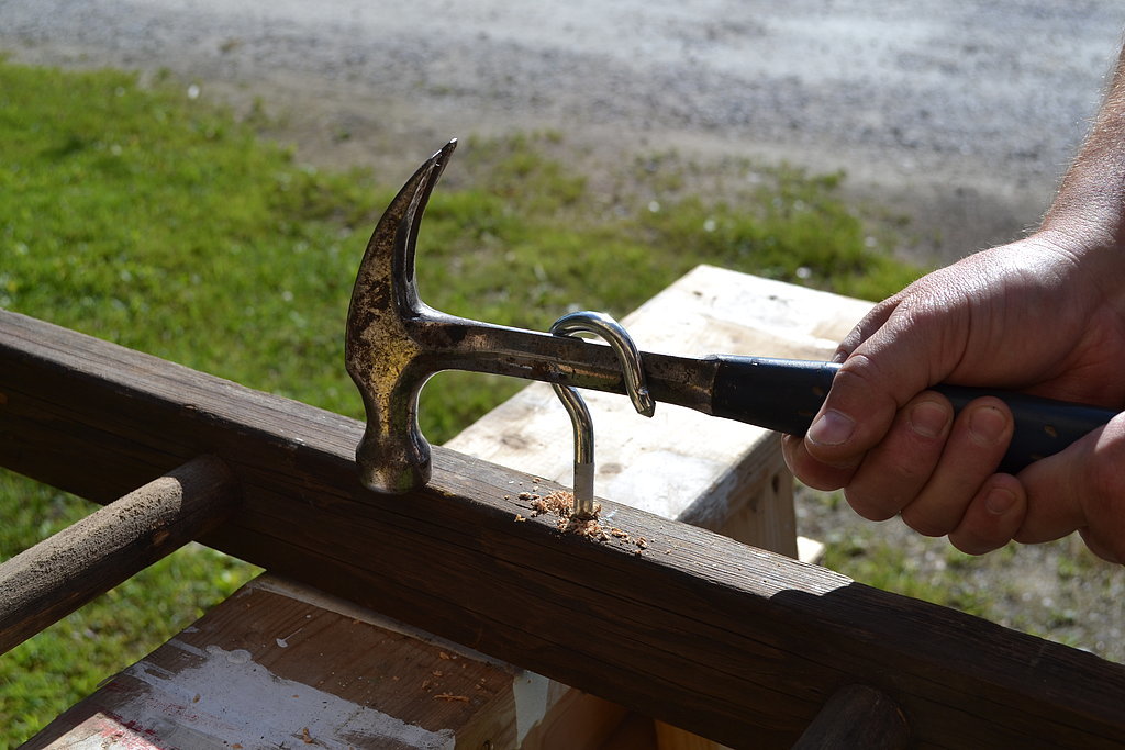 You want to have to use a hammer handle to spin the hook around, making sure it is snug fitting. Make sure that all are facing the direction you want them to be in once you're done.
