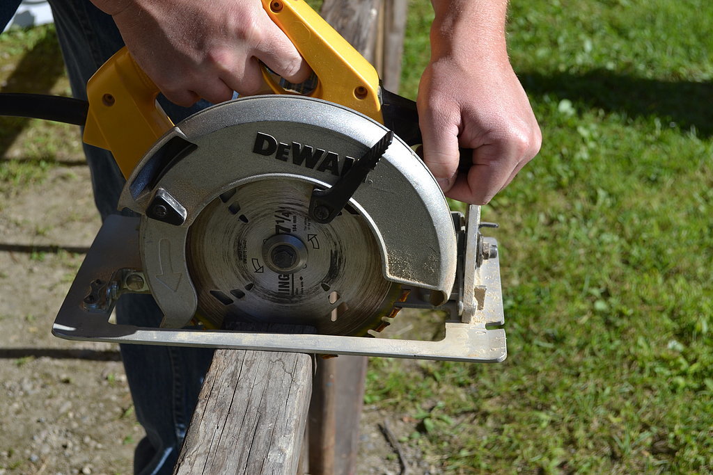 Using a circular saw (or a hand saw), cut the ladders at the length you want them for the chandelier. 
