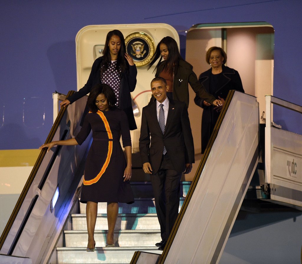 Michelle Obama stepped off the plane in a modest but bold printed dress by Narciso Rodriguez.
