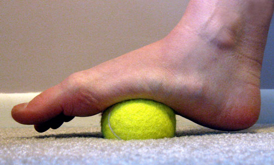 massage-your-feet-with-a-tennis-ball-popsugar-fitness