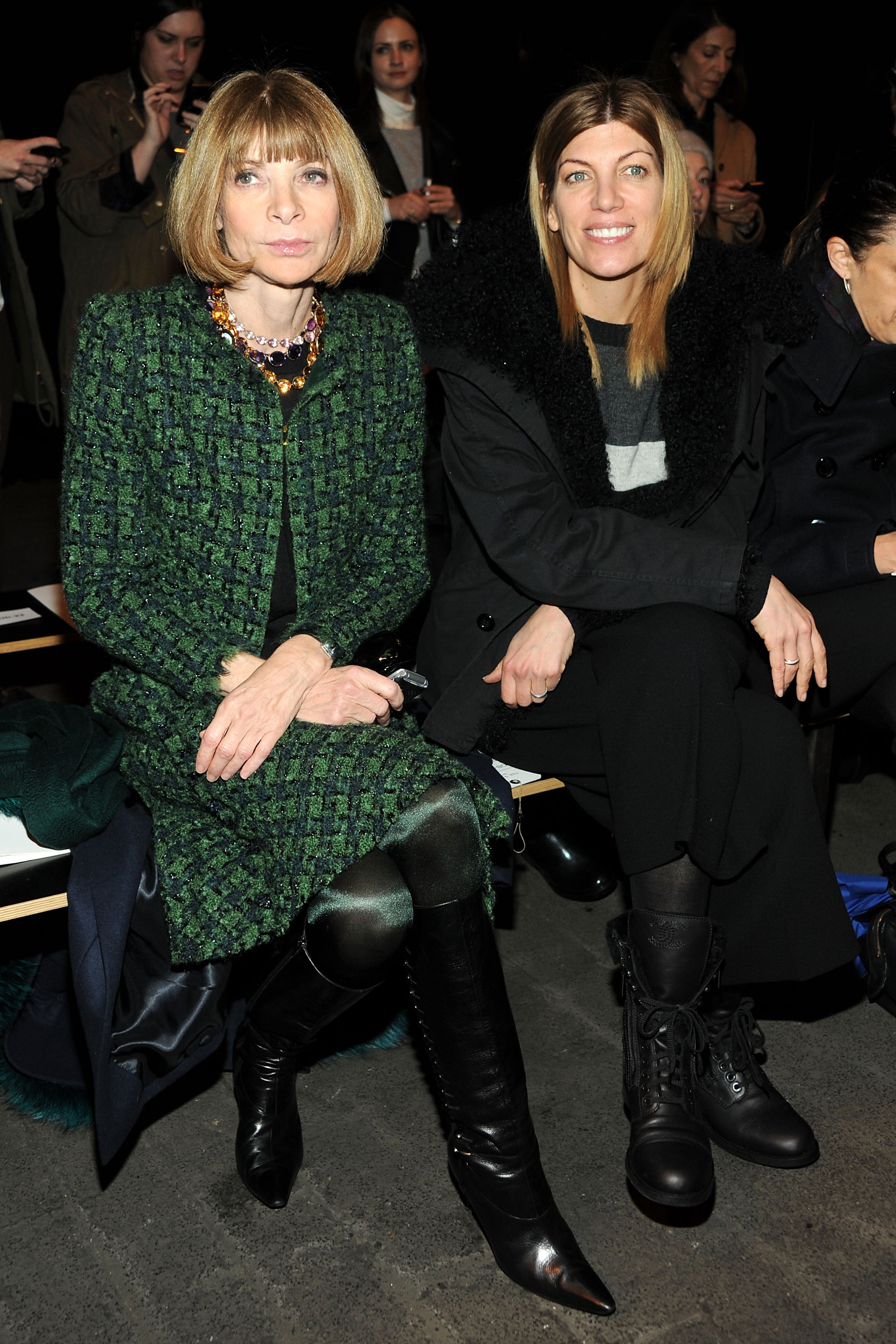 Anna Wintour (in a green plaid skirt suit and black knee-high boots ...