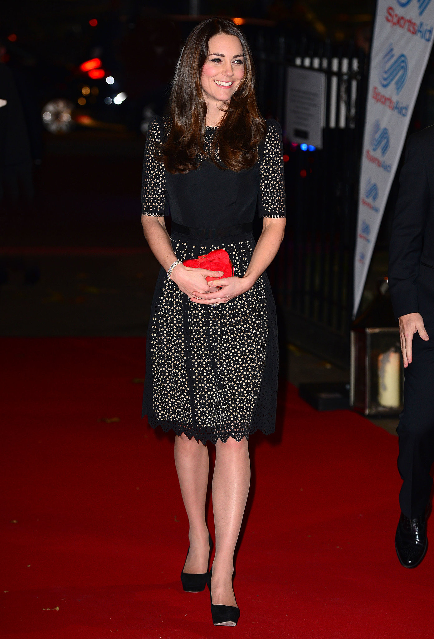 Kate Middleton punctuated a little black lace dress with a red clutch ...