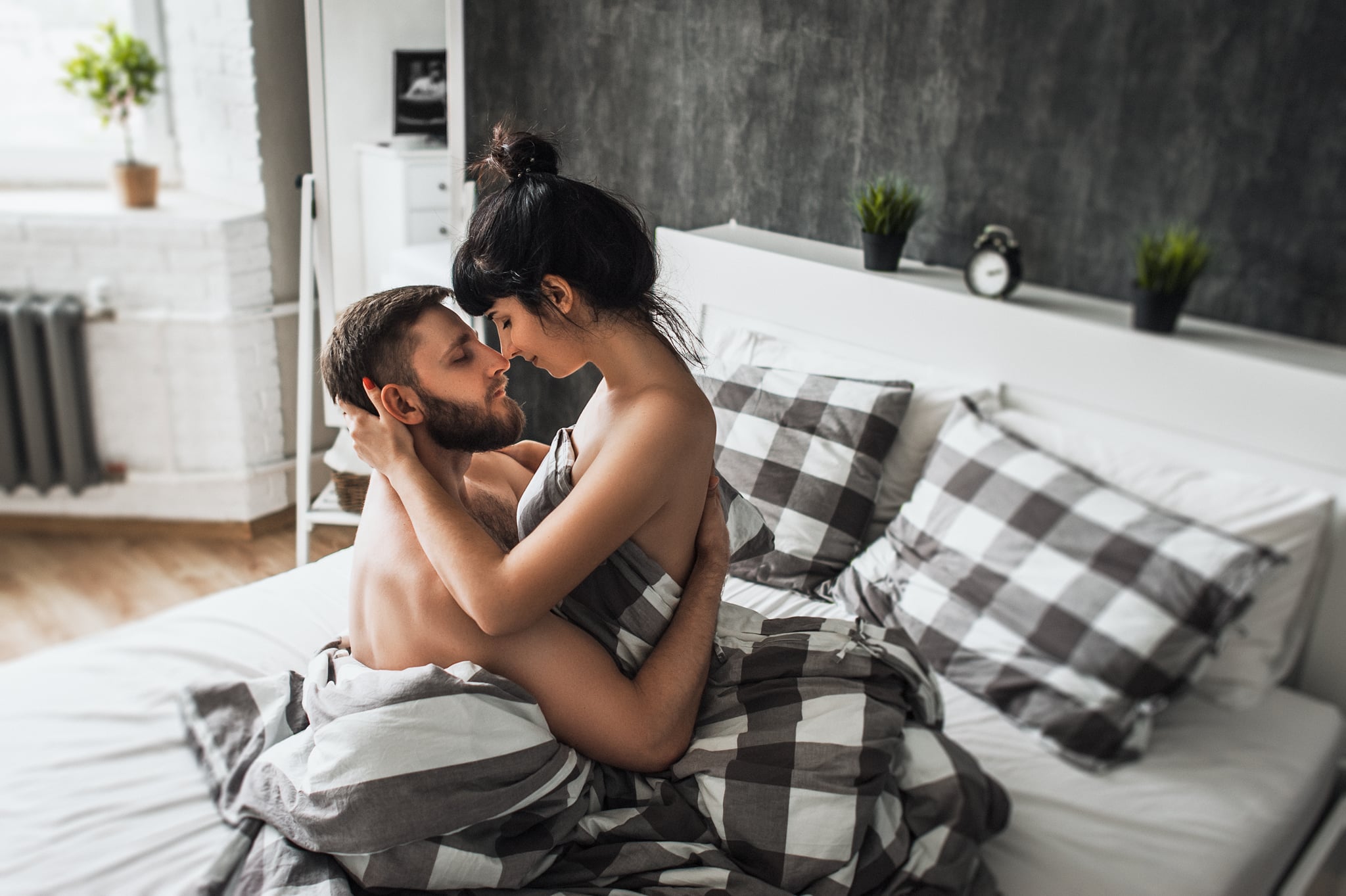 Man and Woman In Bed Gazing Into Each Other's Eyes