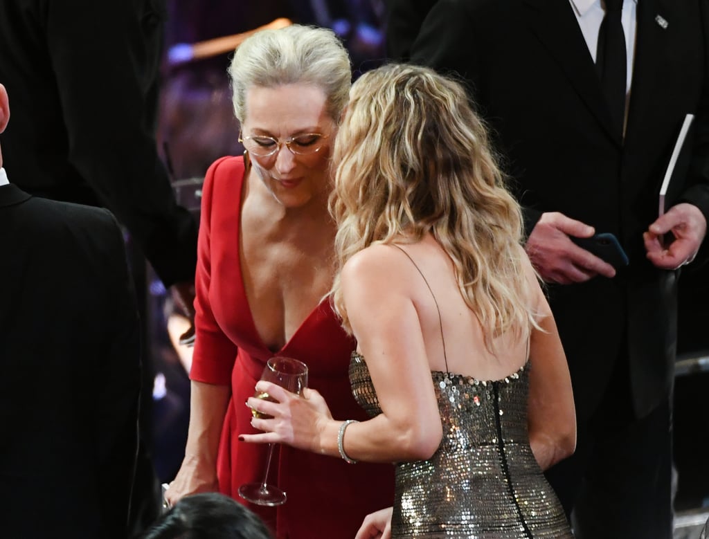 Meryl Streep was stopped by Jennifer Lawrence (wine still in hand) for a chat.