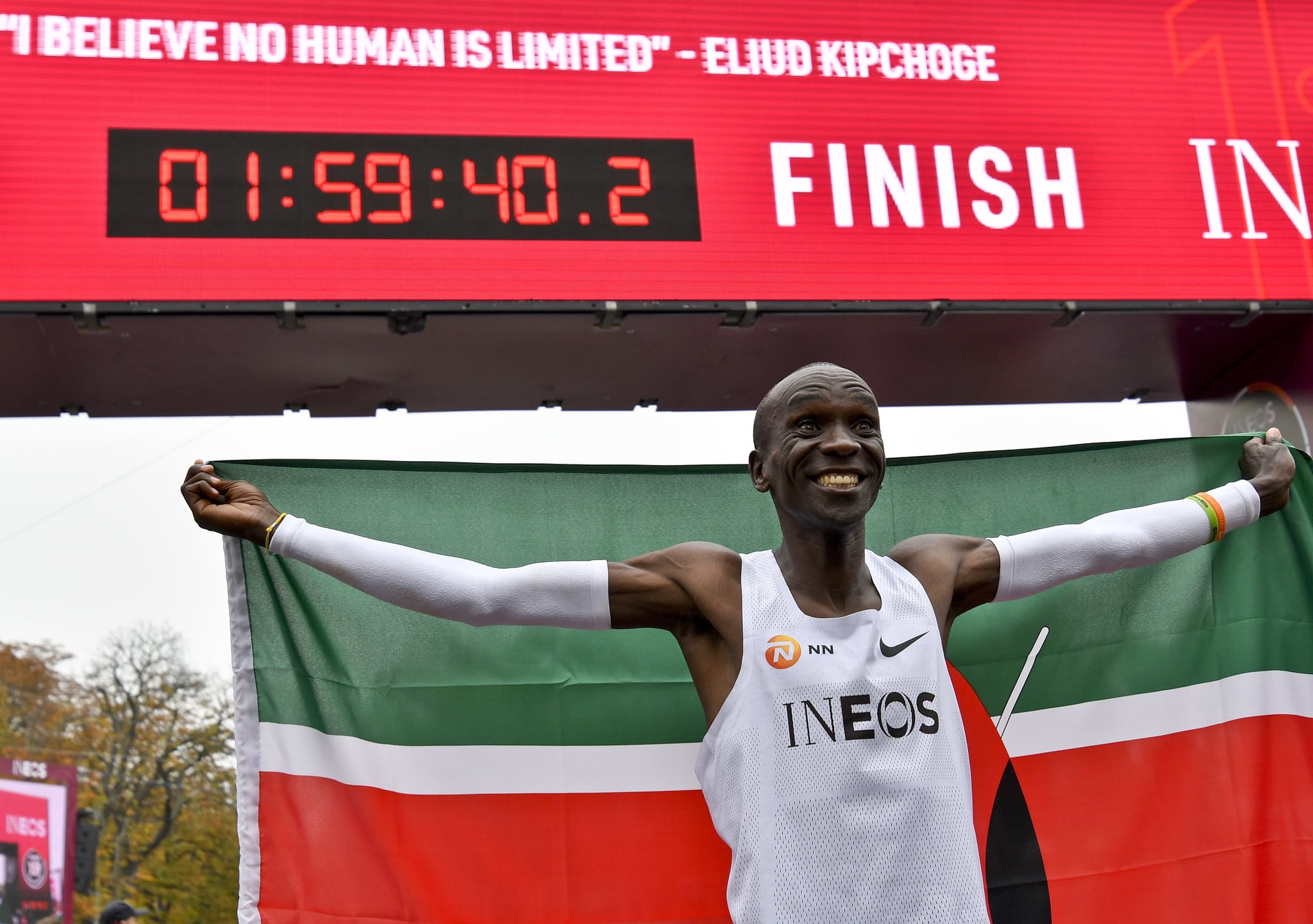 TOPSHOT - Kenya's Eliud Kipchoge (white jersey) celebrates after busting the mythical two-hour barrier for the marathon on October 12 2019 in Vienna. - Kipchoge holds the men's world record for the distance with a time of 2hr 01min 39sec, which he set in the flat Berlin marathon on September 16, 2018.He tried in May 2017 to break the two-hour barrier, running on the Monza National Autodrome racing circuit in Italy, failing narrowly in 2hr 00min 25sec. (Photo by HERBERT NEUBAUER / APA / AFP) / Austria OUT (Photo by HERBERT NEUBAUER/APA/AFP via Getty Images)