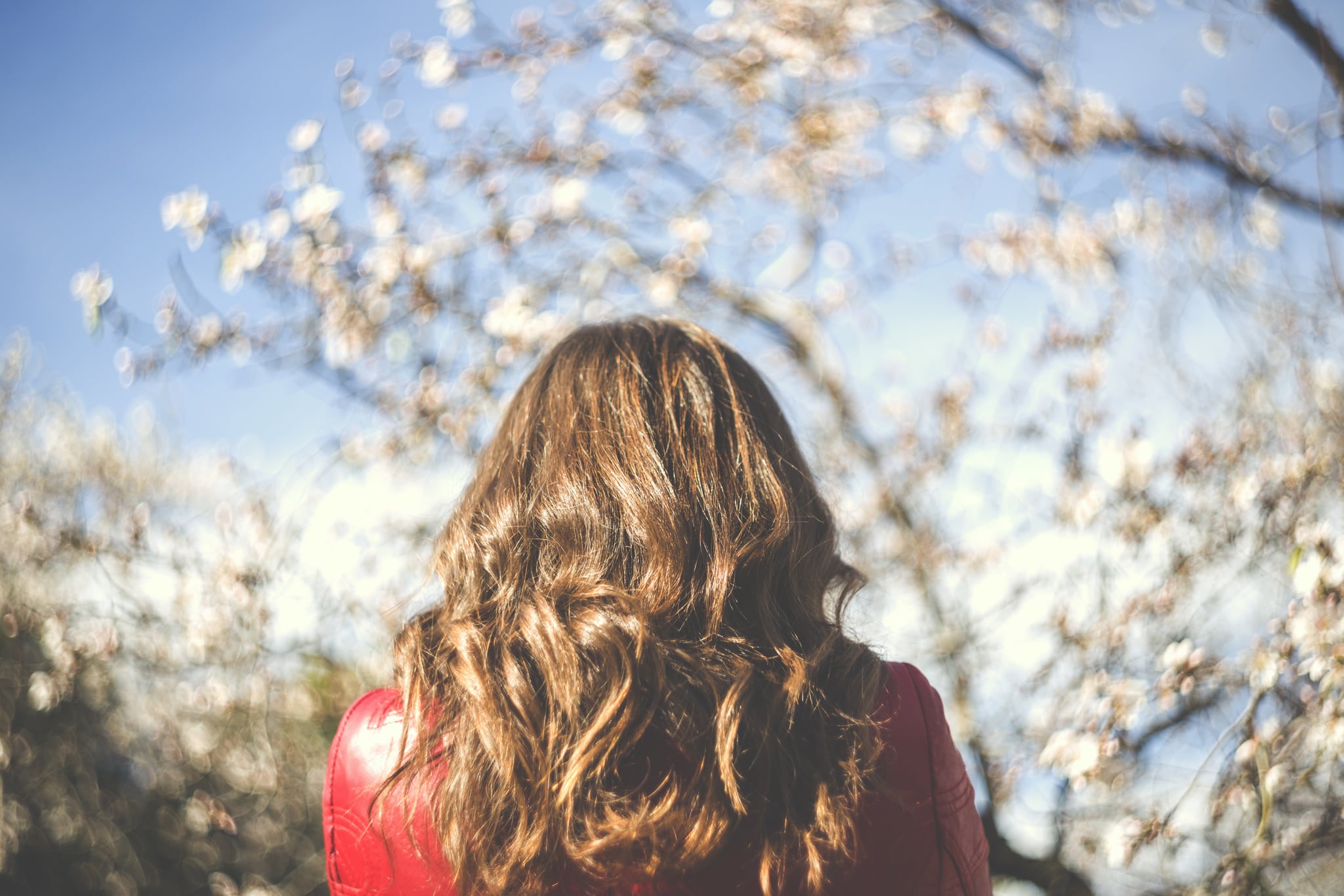 Young woman with a red leather jacket outdoors