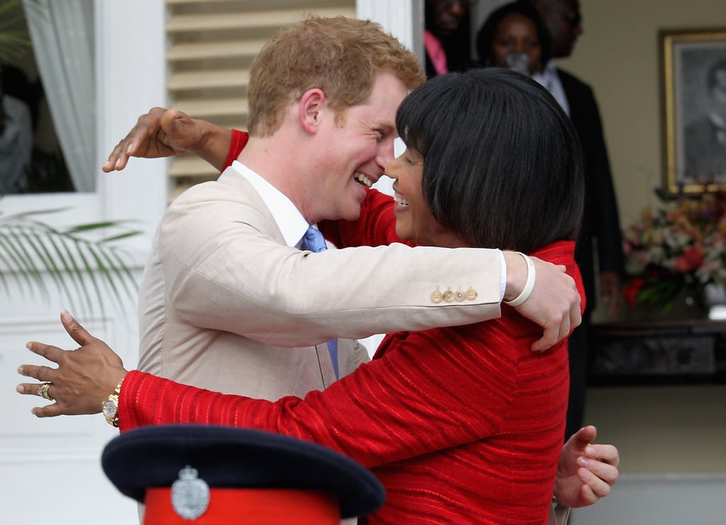 Harry embraced Prime Minister of Jamaica, Portia Simson-Miller, at the Devon House in 2012.