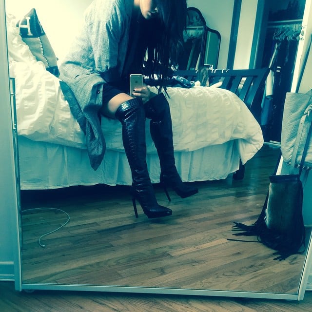 Selena knows there's nothing sexier than over-the-knee boots with a short skirt and a mirror selfie.