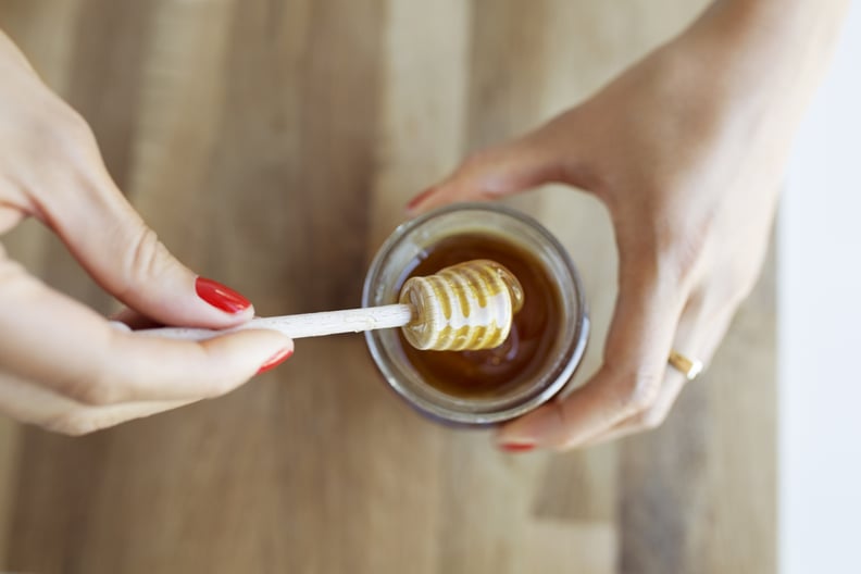 Adding honey to hair conditioner for softer tresses.