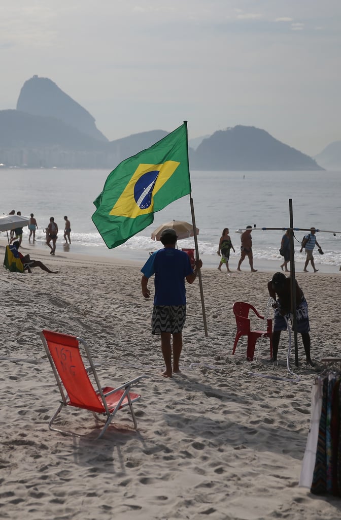 A man carried his Brazilian flag along the beach in Rio de Janeiro.