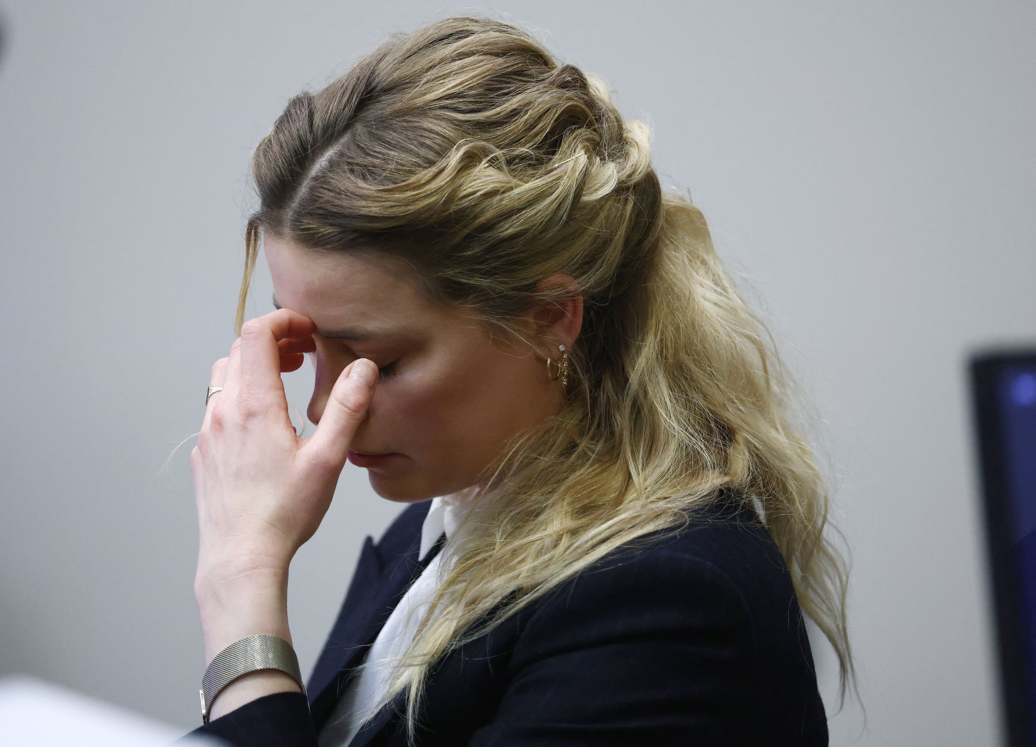 US actress Amber Heard reacts as she listens to an audio recording of she and US actor Johhny Depp arguing during the 50 million US dollar Depp vs Heard defamation trial at the Fairfax County Circuit Court in Fairfax, Virginia, April 21, 2022. - Actor Johnny Depp is suing ex-wife Amber Heard for libel after she wrote an op-ed piece in The Washington Post in 2018 referring to herself as a public figure representing domestic abuse. (Photo by Jim LO SCALZO / POOL / AFP) (Photo by JIM LO SCALZO/POOL/AFP via Getty Images)