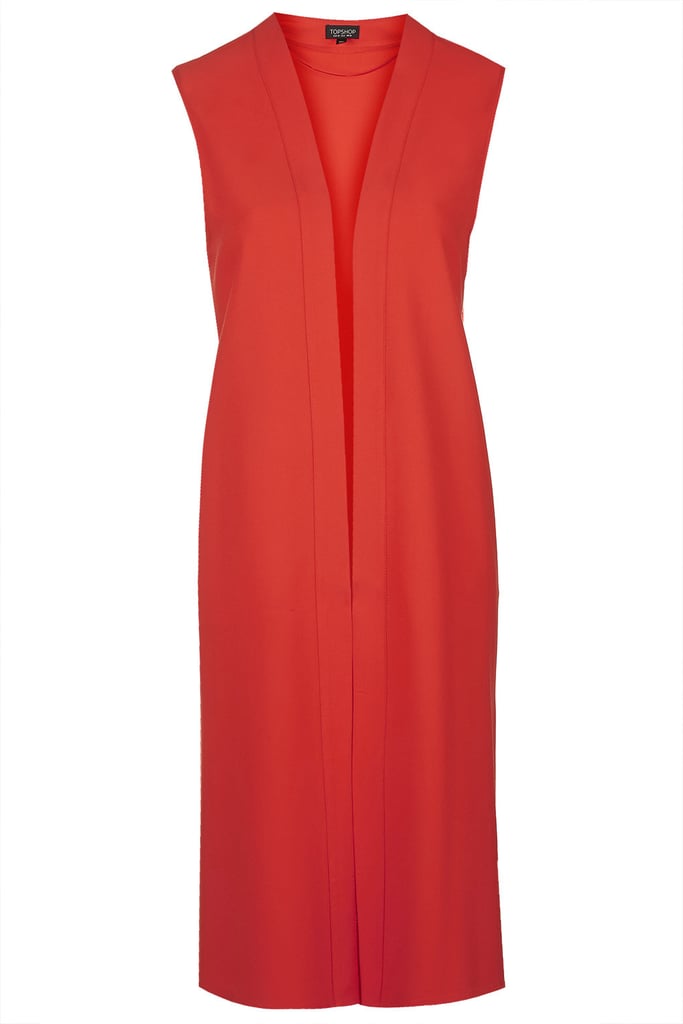 Some people say blazers are their go-to for days when they don't know what to wear. Mine? Vests. Topshop's bright red sleeveless duster ($75) is bound to amp up even the most basic jeans and a t-shirt combo. I'm sold.
— SS