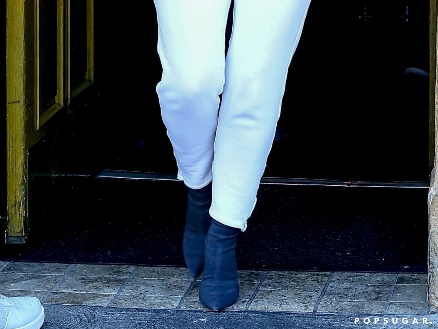 Who made Kim Kardashian's white sweatpants and sneakers?