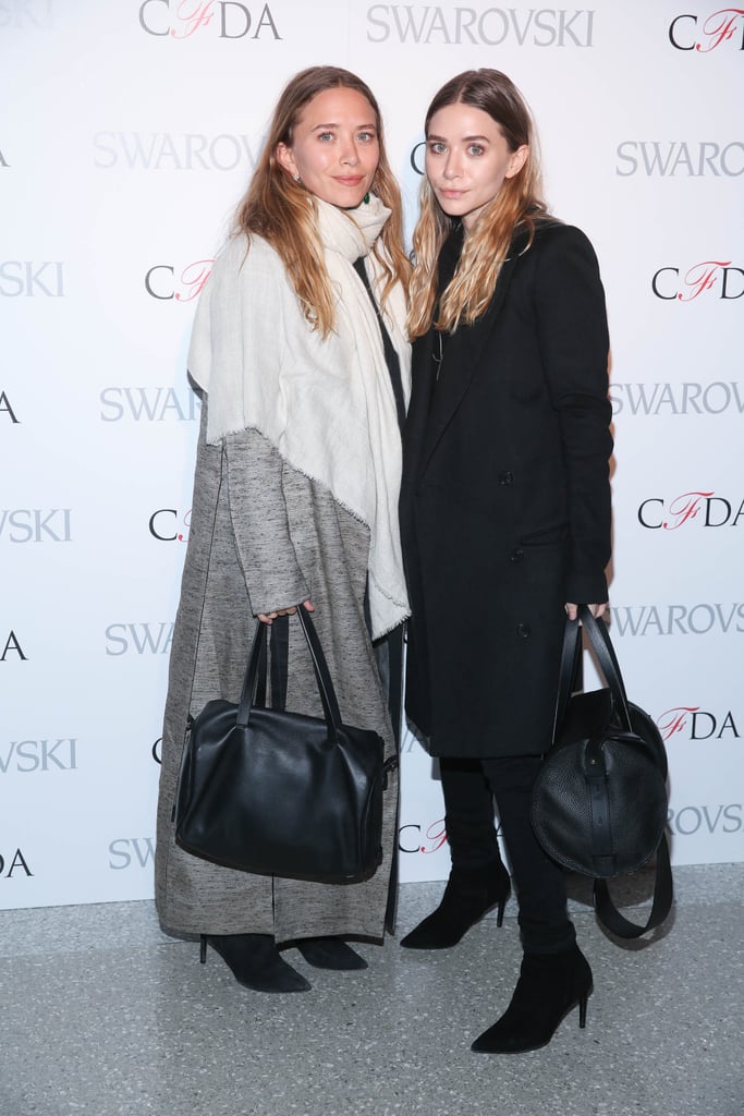 Twinning combo: Cozy coats were the style of choice at the 2015 CFDA announcement party.

Ashley sported a knee-length tuxedo coat in her signature black.
Mary-Kate accessorized her gray floor-length coat with a white scarf.
