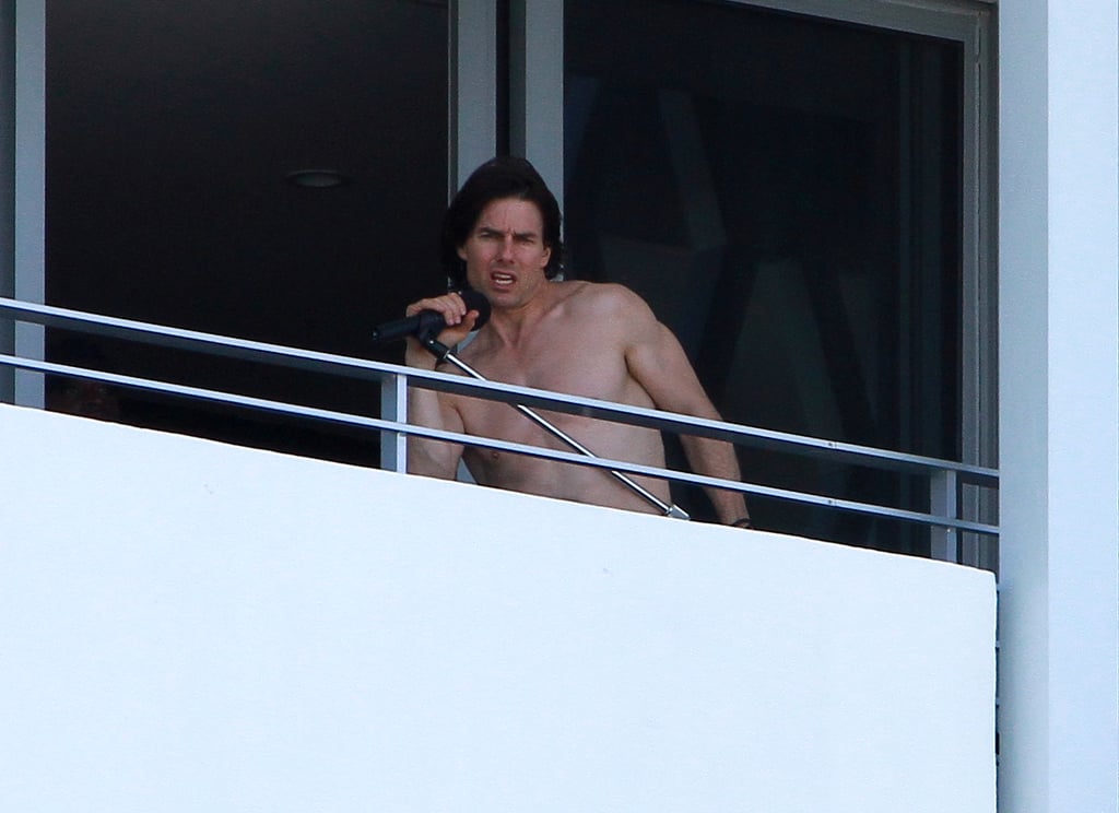 A shirtless Tom Cruise rocked out on his hotel balcony in July 2011.