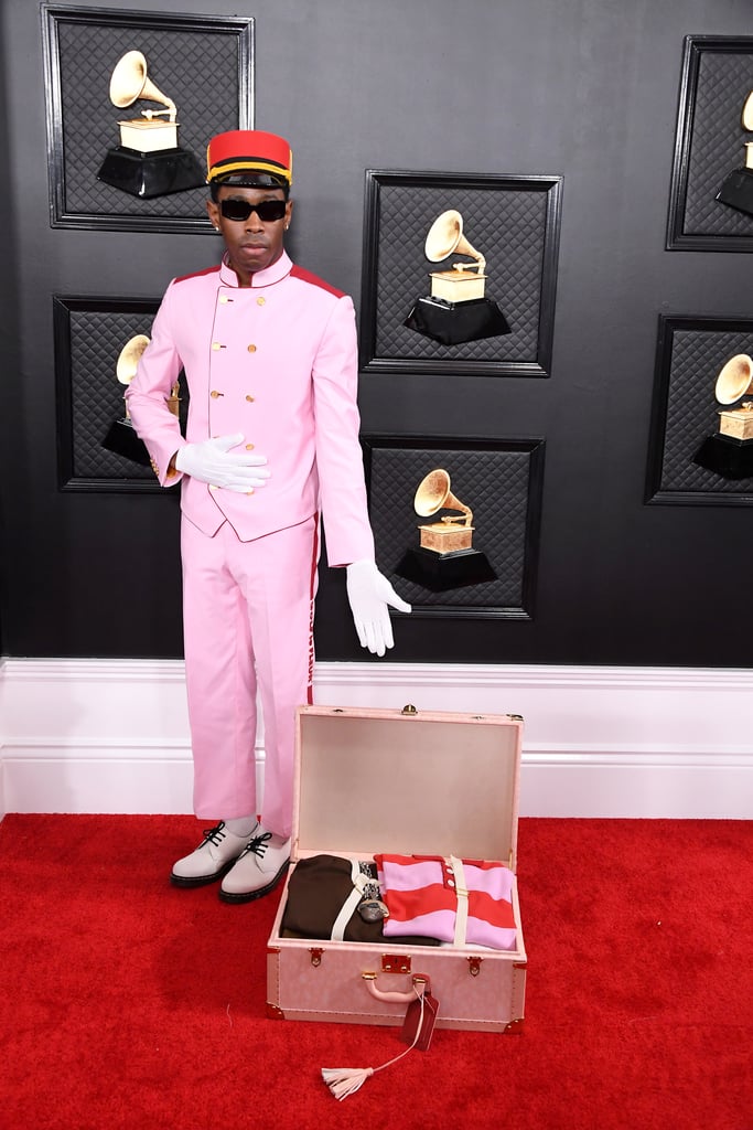 The Grammys outfit that sparked a thousand memes. Tyler paid homage to Wes Anderson's The Grand Budapest Hotel in this pink bellboy outfit by his brand Golf le Fleur.