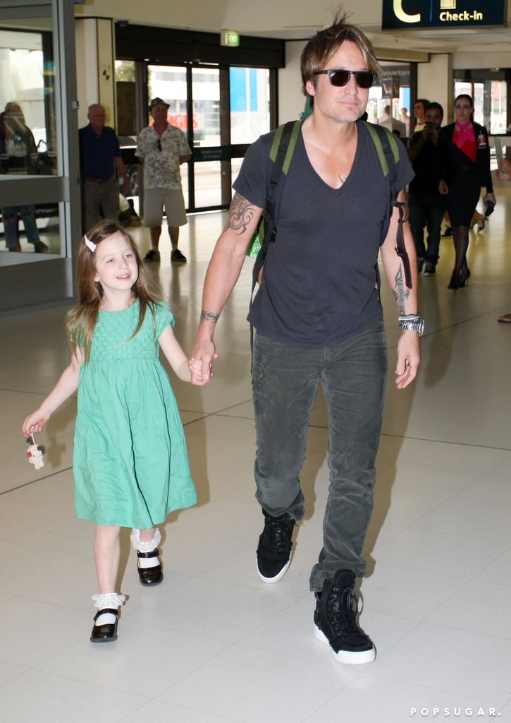 Keith held Sunday's hand as they walked through the airport.