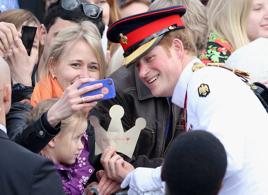 In May 2014, Prince Harry paused to take a selfie with a young woman in Estonia.