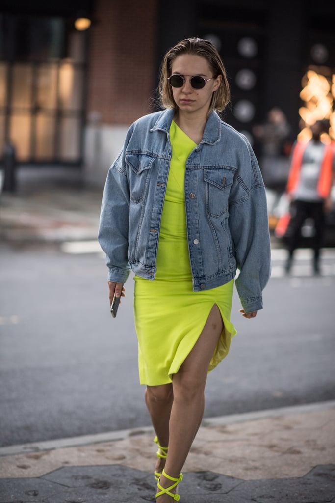 An oversize denim jacket quickly tones down an electric-yellow outfit.
