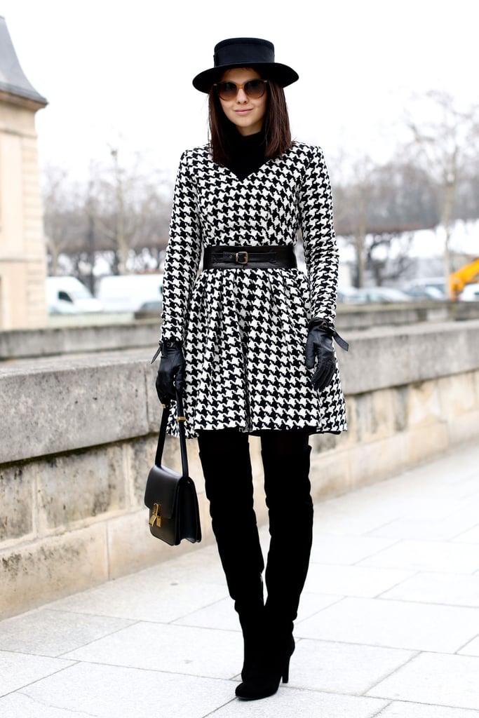 A houndstooth-print white and black coat gave over-the-knee boots ...