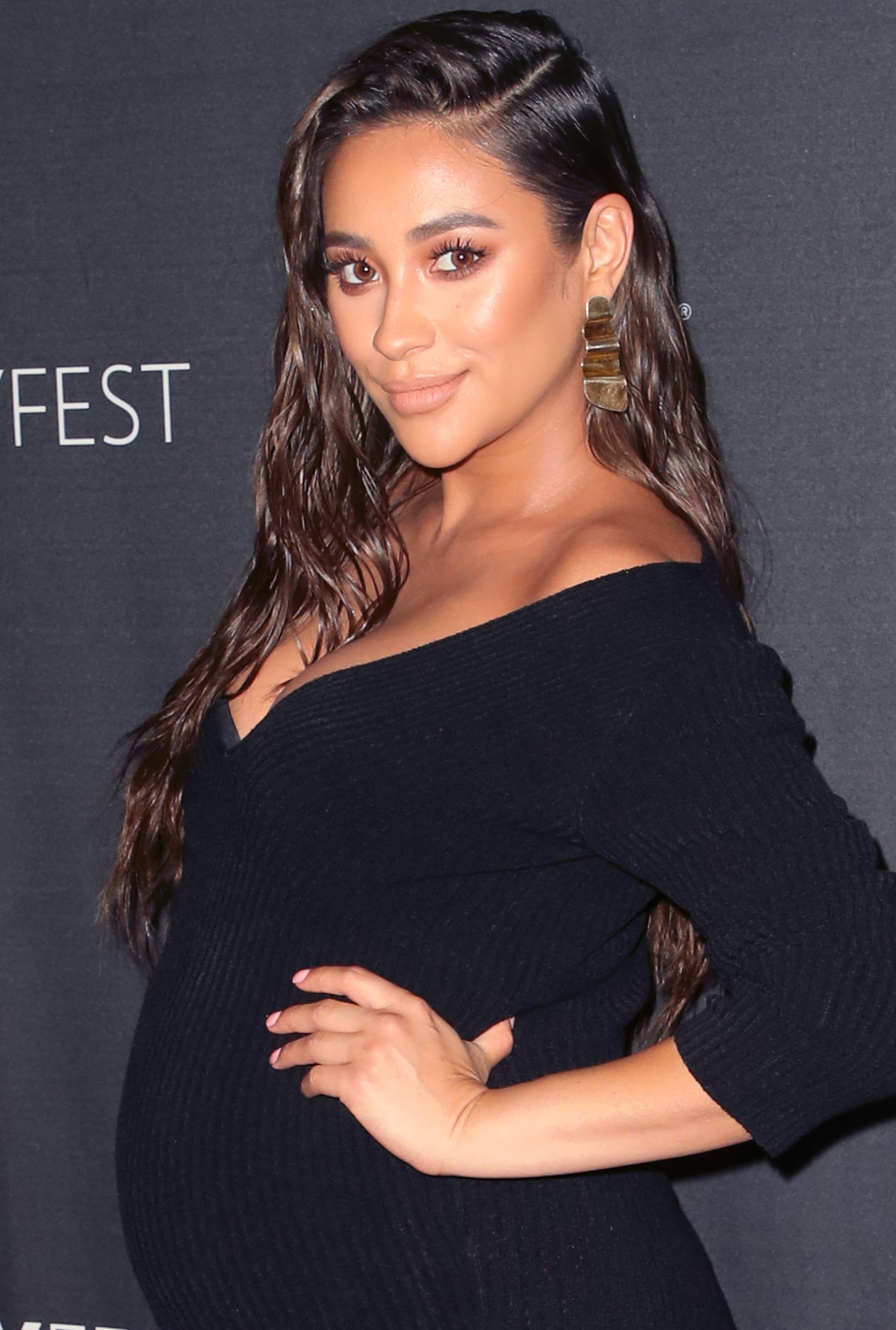 Shay Mitchell wears an oversized shirt over sports bra and leggings while  leaving a hot Pilates