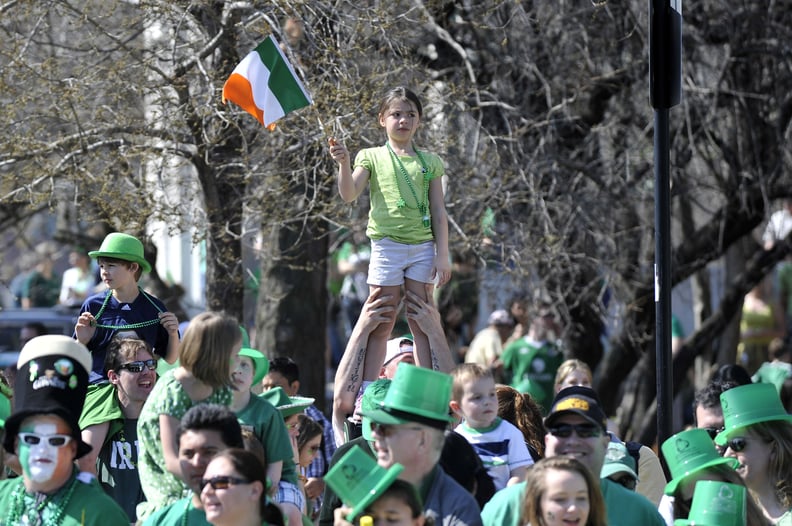 There are painted faces and kids standing on shoulders.