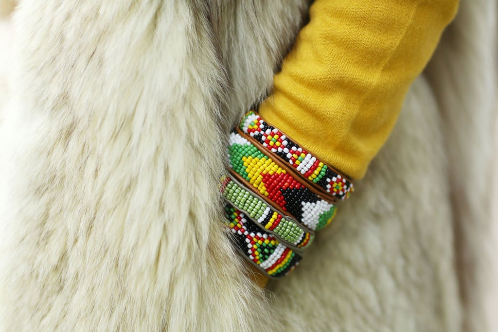 Eclectic bracelets brighten up a furry layer. 
Source: Tim Regas