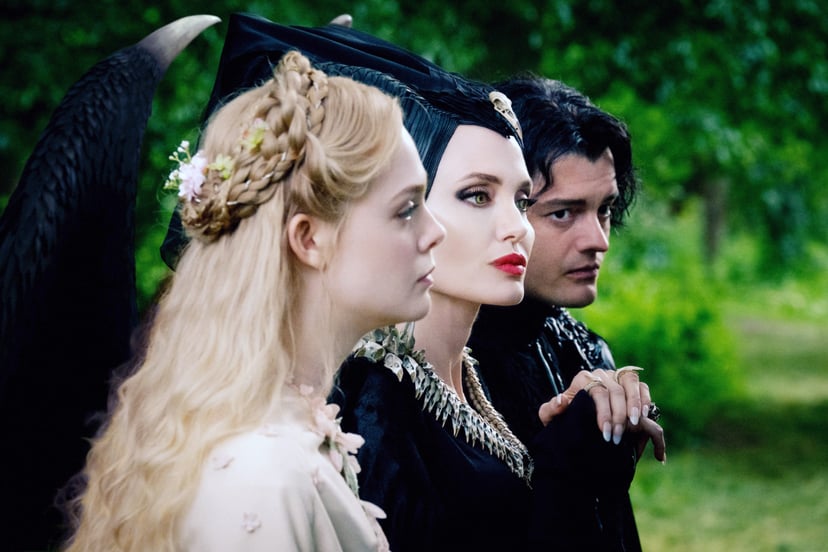 MALEFICENT: MISTRESS OF EVIL, from left: Elle Fanning as Aurora, Angelina Jolie as Maleficent, Sam Riley as Diaval, 2019. ph: Jaap Buitendijk /  Walt Disney Studios Motion Pictures / courtesy Everett Collection