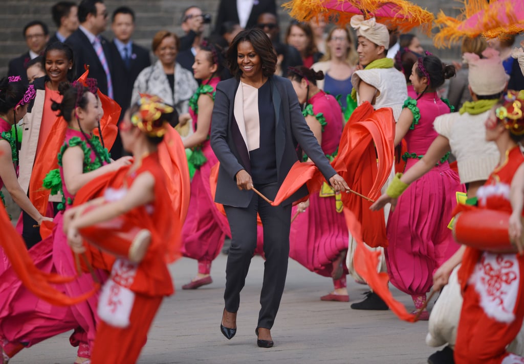 First Lady Michelle Obama joined performers waving flags in Xi'an.