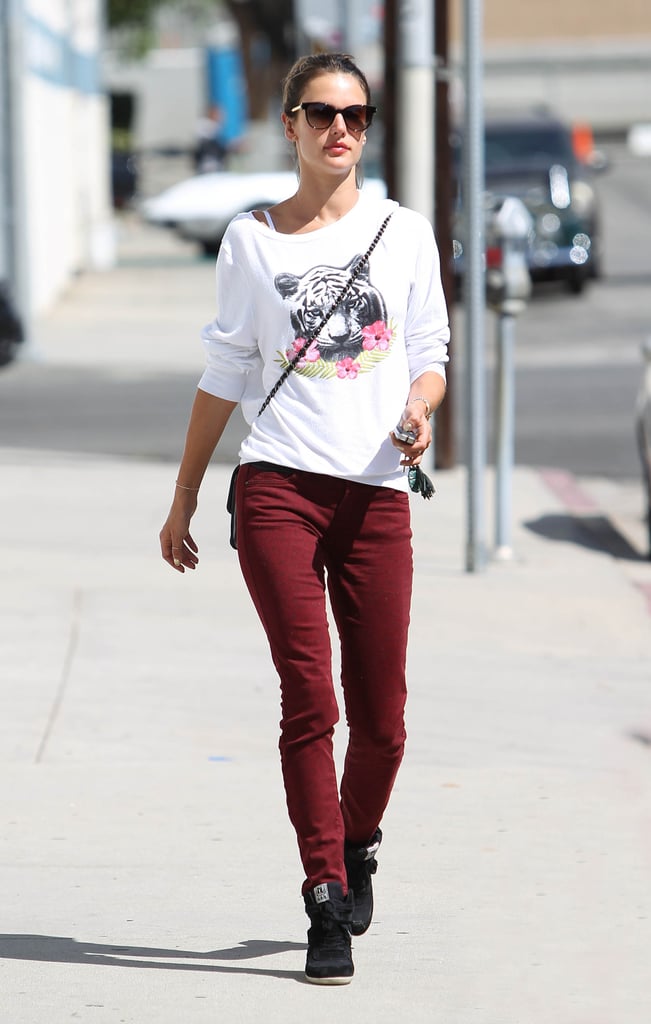 Hey, we've seen that sweatshirt before! This time she wore it with dark red jeans and sneakers.