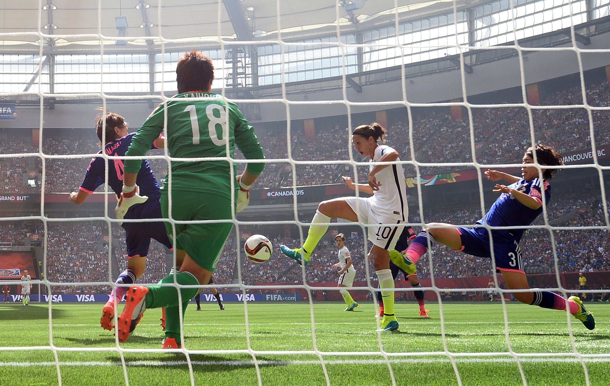 VANCOUVER, BC - JULY 05:  Carli Lloyd #10 of the United States of America scores the team's second goal and a hat trick in soccer against Saki Kumagai #4, Azusa Iwashimizu #3 and goalkeeper Ayumi Kaihori #18 of Japan in the FIFA Women's World Cup Canada 2015 Final at BC Place Stadium on July 5, 2015 in Vancouver, Canada.  (Photo by Dennis Grombkowski/Getty Images)