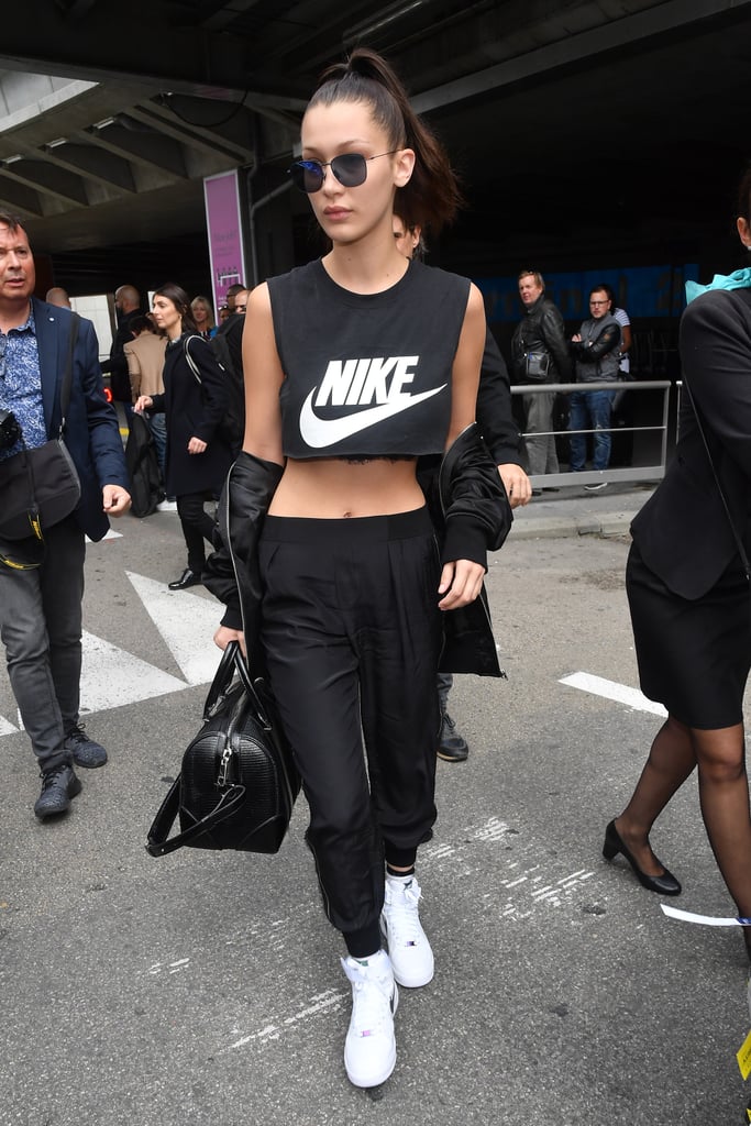 Bella's nylon track pants were cinched at the ankle and low slung to better show off her Nike crop top.
