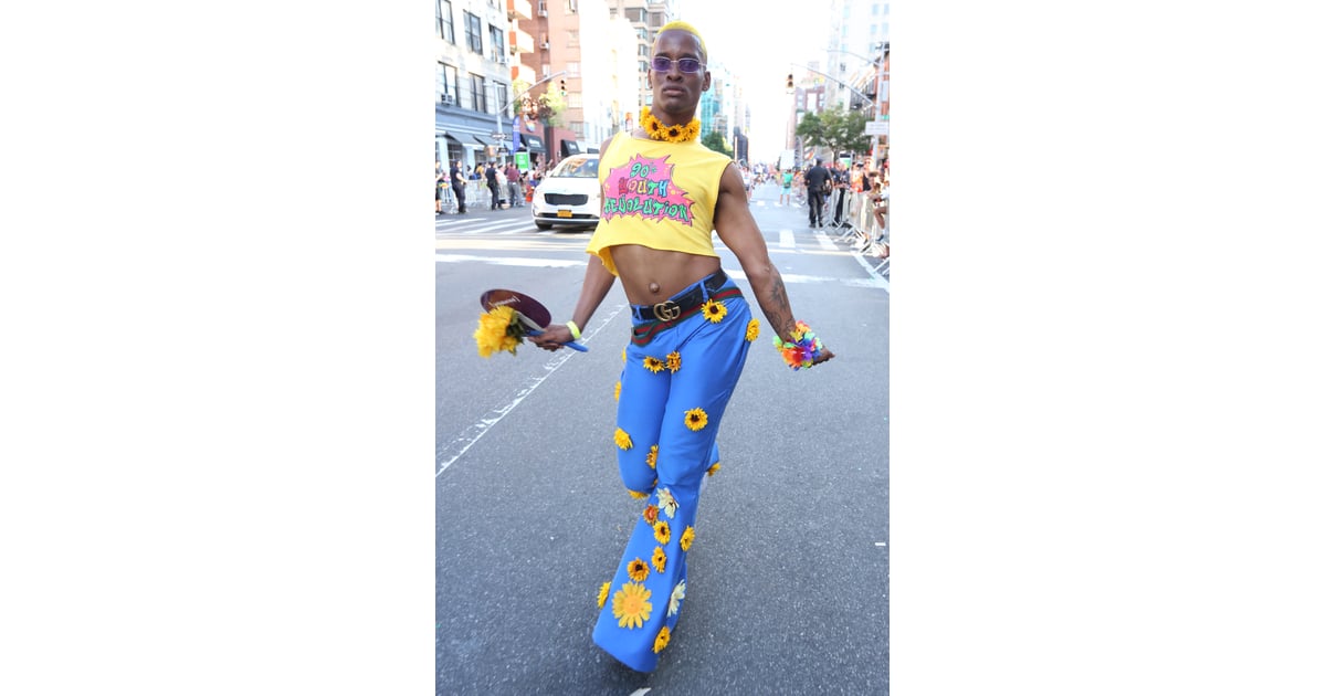 A guest wearing a cropped tee and sunflower appliqué pants with a