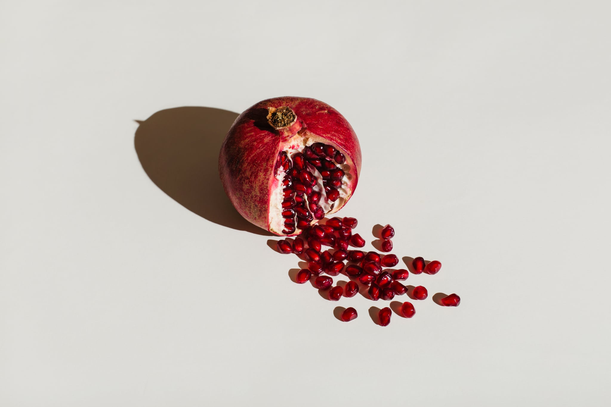 ut pomegranate on a white background. Menstruation concept. Symbol of vagina. Gynecology, female intimate health