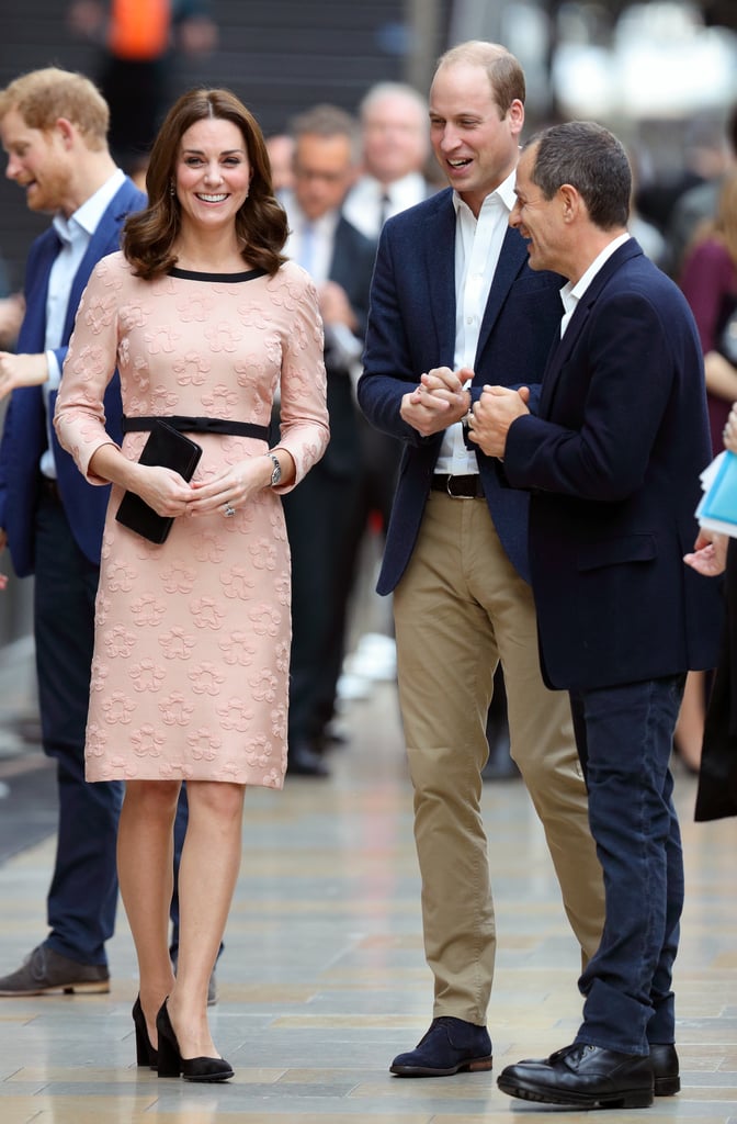 On Oct. 16, Kate attended the Charities Forum Event at Paddington Station with Prince William and Prince Harry. She wore a pink three-quarter sleeve dress from Orla Kiely that featured a playful 3-D floral design. She stayed up on her toes with a pair of black block heels that matched the trimmings on her dress.