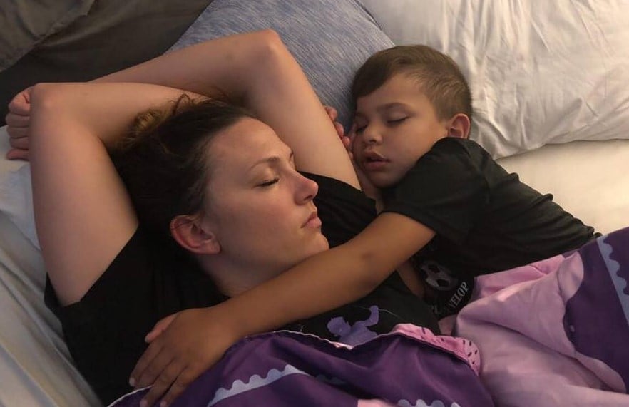 Carter snuggles with his mom.
