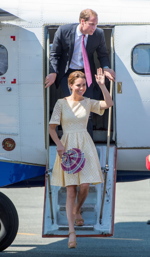 Kate Middleton in a chic yellow eyelet dress with Prince William during an arrival in Honiara, Solomon Islands, in September 2012.