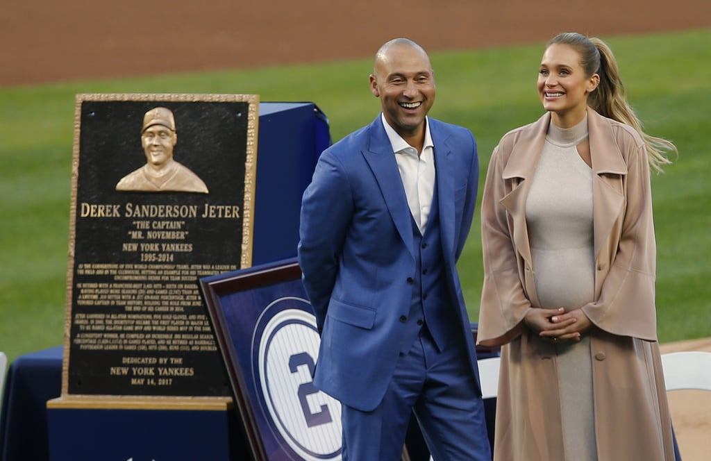 Derek Jeter had the support of his wife, Hannah, as he retired his #2 jersey at Yankee Stadium on Sunday night. The couple, who are expecting their first child, were all smiles as they walked hand in hand across the field. While the retired New York Yankees shortstop looked handsome in a blue suit, his wife showed off her growing baby bump in a beige dress and trench coat. Their sweet outing comes just a few months after Hannah revealed they are expecting a baby girl. Even though they haven't agreed on a name quite yet, she joked that their little one will "run circles around him."