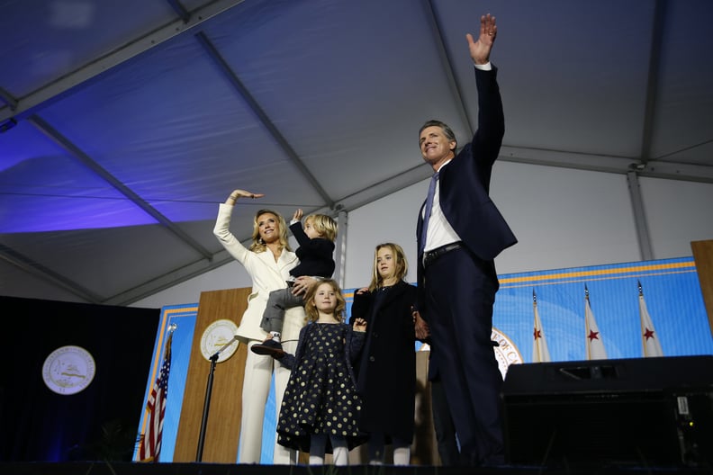 SACRAMENTO, CA - JANUARY 07: Governor Gavin Newsom gestures to the crowd alongside wife Jennifer Siebel Newsom and children (L-R) Dutch, Montana, and Brooklynn on January 7, 2019 in Sacramento, California. Gavin Newsom will begin his first term as the 40t