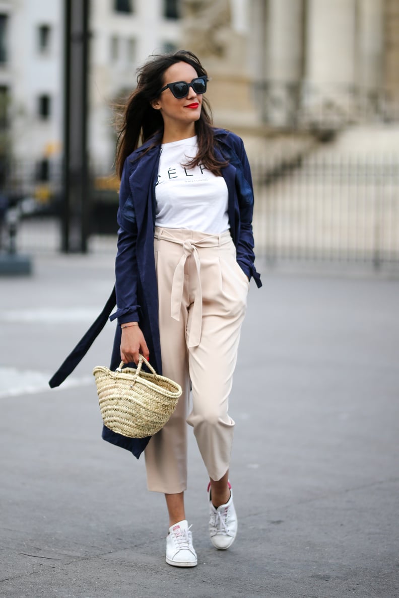 Style a luxe outfit with a straw bag and sneakers.