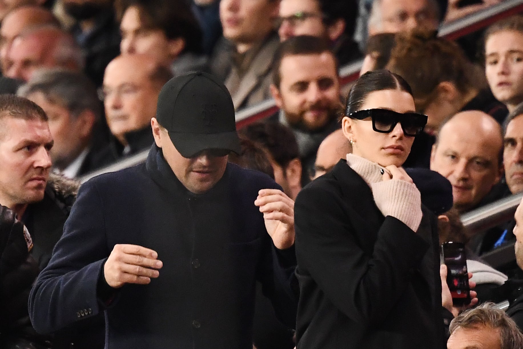 US actor Leonardo Di Caprio (C) and his partner Argentinian and US model Camilla Morrone (R) attend the UEFA Champions League Group C football match between Paris Saint-Germain (PSG) and Liverpool FC at the Parc des Princes stadium, in Paris, on November 28, 2018. (Photo by FRANCK FIFE / AFP)        (Photo credit should read FRANCK FIFE/AFP via Getty Images)
