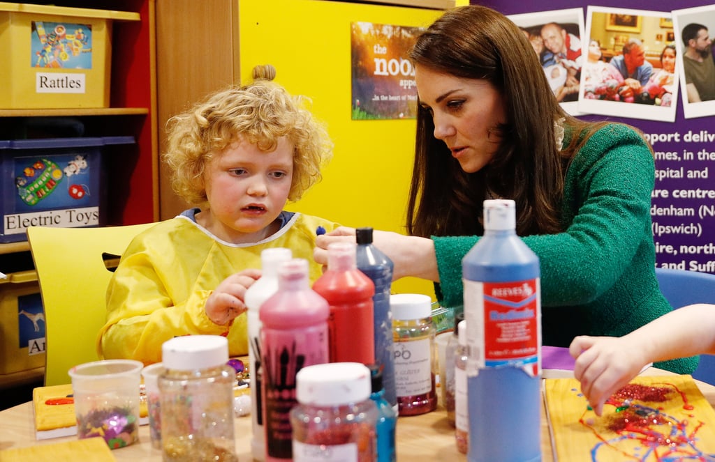 Kate looked serious while painting at a children's hospital in January 2017.