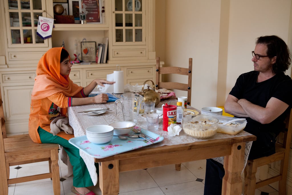 Malala chats with the director at the family dinner table.