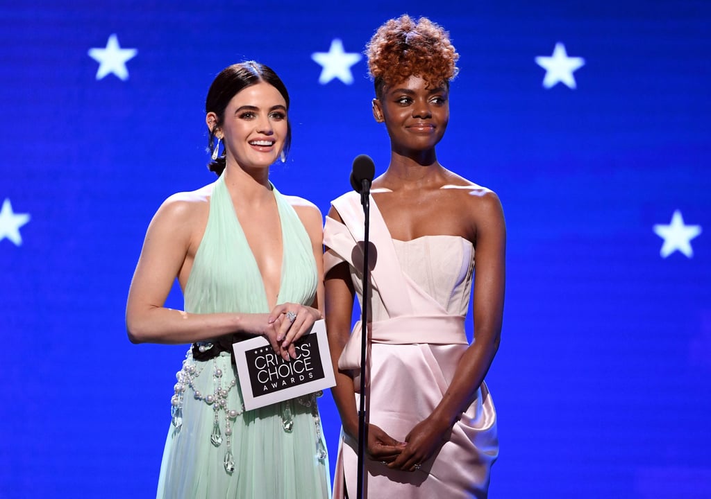 If we could give a Critics' Choice Award for the most endearing presenters, we'd hand it to Lucy Hale and Ashleigh Murray without blinking an eye. On Sunday, the Katy Keene costars took the stage together to deliver the awards for best supporting actor and actress in a drama series. Both stars looked absolutely stunning as Lucy rocked a seafoam custom DKNY dress with glitzy embellishments and Ashleigh modeled a lustrous lavender gown. 
Their presentation went smoothly, save for one little flub. While revealing the winners of the categories — Billy Crudup from The Morning Show and Jean Smart from Watchmen — Lucy and Ashleigh weren't exactly in unison while announcing the names. They couldn't help but laugh at the moment, which made it more charming than anything. We're all human, right? Look ahead to see more photos of the adorable duo at the ceremony!
