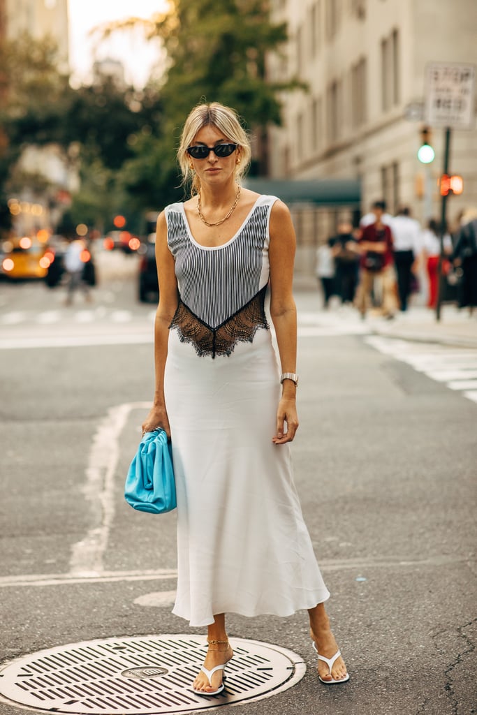 Allow a mixed-material dress to help you combat the summer heat, and style it with a bright blue clutch and thong sandals.