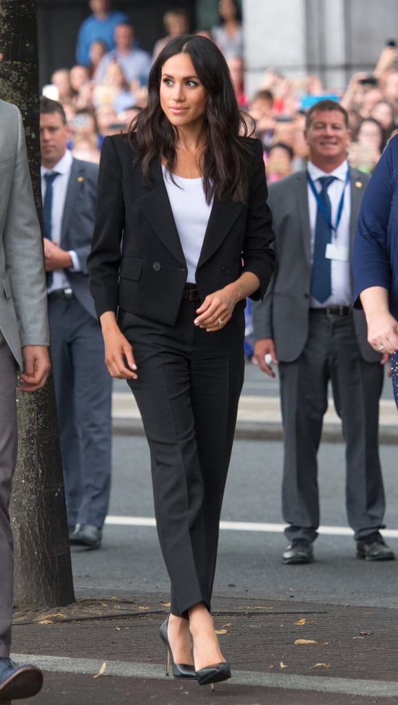 Meghan sported a relaxed white tee underneath this Givenchy pantsuit in Ireland in July 2018.