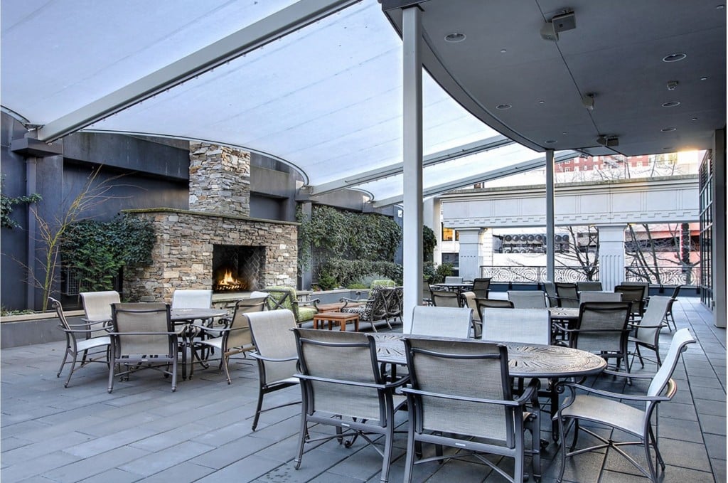 A furnished courtyard with a stone fireplace can be used by Escala residents.